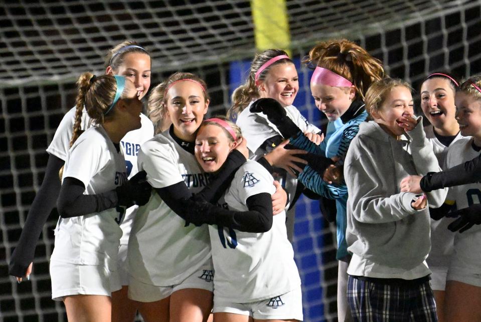 The Sturgis East team joins their goalie Keegan Endres after defeating Mashpee 2-1 in preliminary round soccer.