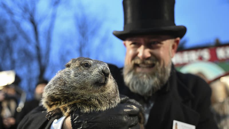 Groundhog Club handler A.J. Dereume holds Punxsutawney Phil, the weather prognosticating groundhog, during the 138th celebration of Groundhog Day on Gobbler’s Knob in Punxsutawney, Pa., Friday, Feb. 2, 2024. Phil’s handlers said that the groundhog has forecast an early spring.