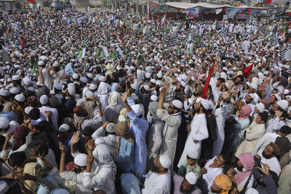 Supporters of the Jamiat Ulema-e-Islam party listen a speech by their leader while they gather to start an anti-government march, in Karachi, Pakistan, Sunday, Oct. 27, 2019. Thousands of supporters of the ultra-religious party are gathering in Karachi to start a large anti-government march on Pakistan's capital farther north. (AP Photo/Fareed Khan)