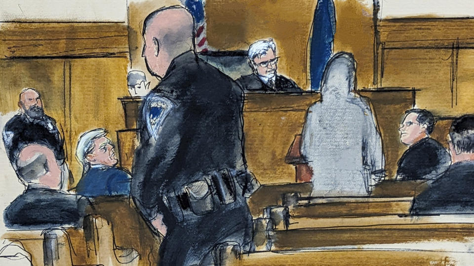 Former President Donald Trump, second from left, watches juror number d2 speak at the podium to Judge Juan Merchan in Manhattan criminal court regarding her desire to be excused from the jury after " sleeping on it" and having concerns about her ability to be fair and impartial, Thursday, April 18, 2024, in New York. (Elizabeth Williams via AP, Pool)