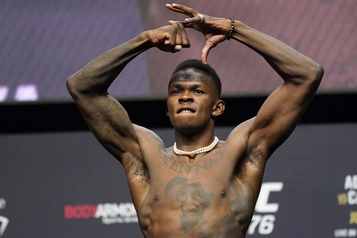 Israel Adesanya poses during a ceremonial weigh-in Friday, July 1, 2022, in Las Vegas. Adesanya is scheduled to fight Jared Cannonier in a middleweight title mixed martial arts bout Saturday at UFC 276 in Las Vegas. (AP Photo/John Locher)