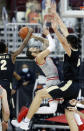 Ohio State guard Duane Washington, center, goes up for a shot between Purdue guard Eric Hunter, left, and center Zach Edey during the first half of an NCAA college basketball game in Columbus, Ohio, Tuesday, Jan. 19, 2021. (AP Photo/Paul Vernon)