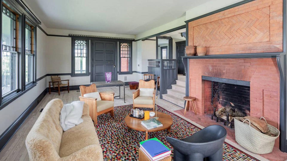 The cozy living room, complete with a brick fireplace. - Credit: Realtor.com