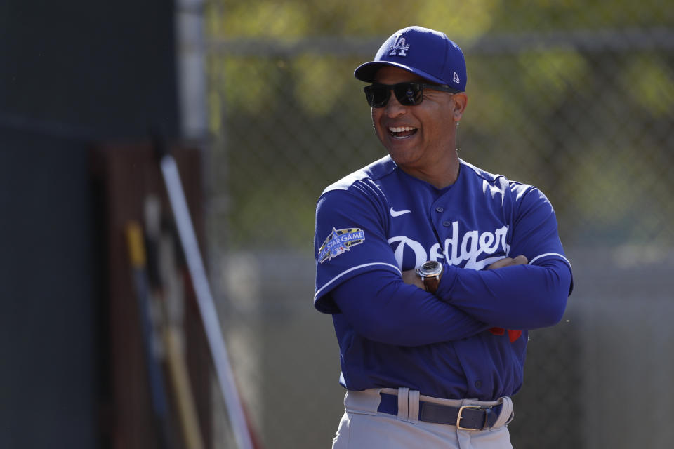 Los Angeles Dodgers manager Dave Roberts looks on during spring training baseball Friday, Feb. 21, 2020, in Phoenix. (AP Photo/Gregory Bull)