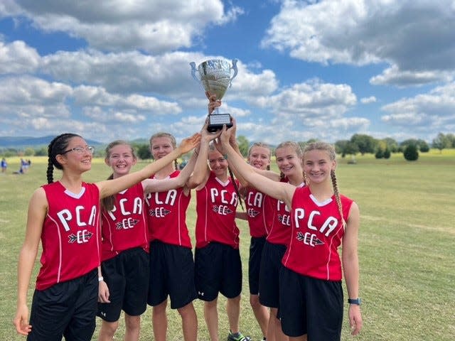 The Pensacola Christian Academy girls team celebrates after taking third in the Southern Showcase on Saturday, Sept. 17, 20222 from the John Hunt Running Park in Huntsville, Ala.