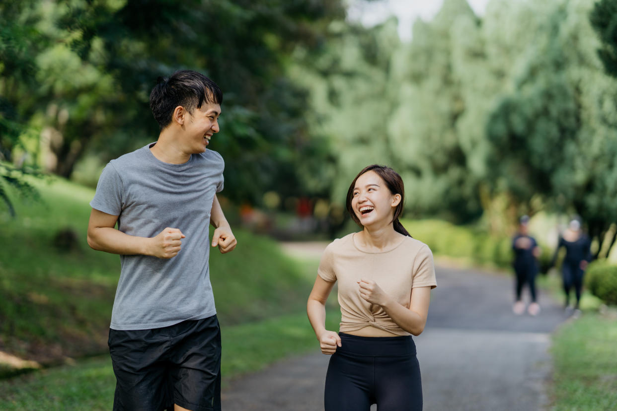 Couple jogging in a public park. (Photo: Getty Images)