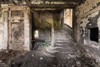 <p>Eerie photographs reveal the abandoned burned-down parliament building where 500 people were killed in the Sukhumi massacre. More than two decades since the conflict, the site remains a visual scar and a reminder of Abkhazia’s battle for independence from Georgia. (Photo: Bob Thissen/Caters News) </p>