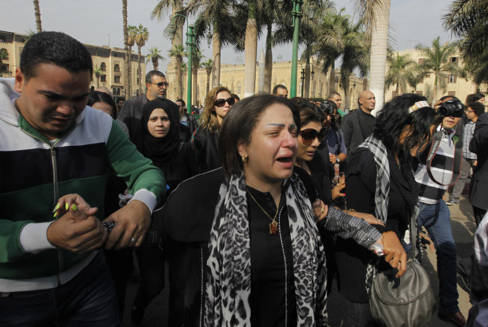 Zeinab Negm, center, a daughter of Egypt’s best known satirical poet, Ahmed Fouad Negm, grieves with others during his funeral outside al-Hussein mosque in Cairo, Egypt, Tuesday, Dec. 3, 2013. Known as the "poet of the people," Negm's use of colloquial Egyptian Arabic endeared him to his countrymen who saw in his verse an unvarnished reflection of how they felt about milestones in their nation's history like the humiliating defeat at the hands of Israel in 1967, the 1979 peace treaty with Israel and the authoritarian rule of Hosni Mubarak. (AP Photo/Amr Nabil)