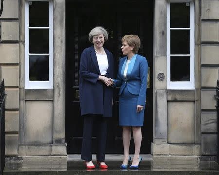 Scotland's First Minister, Nicola Sturgeon (R), greets Britain's new Prime Minister, Theresa May, as she arrives at Bute House in Edinburgh, Scotland, Britain July 15, 2016. REUTERS/Russell Cheyne