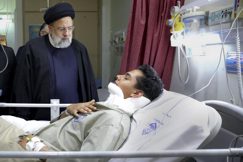 In this photo released by the Iranian Presidency Office, Iranian President Ebrahim Raisi visits a man who was wounded in Wednesday's bomb explosion in the city of Kerman about 510 miles (820 kms) southeast of the capital Tehran, Iran, Friday, Jan. 5, 2024. Iranian officials tried Friday to link Israel and the U.S. to an Islamic State group-claimed suicide bombing, seeking to intertwine the assault with wider Middle East tensions from the Israel-Hamas war. (Iranian Presidency Office via AP)