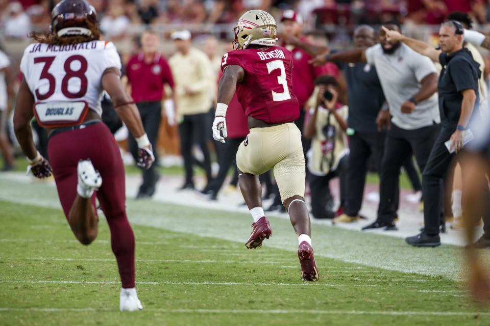 Florida State running back Trey Benson (3) takes off on an 85-yard touchdown run as Virginia Tech linebacker Jayden McDonald (38) pursues as Florida State head coach Mike Norvell, right, points the way to the end zone during the second half of an NCAA college football game, Saturday, Oct. 7, 2023, in Tallahassee, Fla. (AP Photo/Colin Hackley)