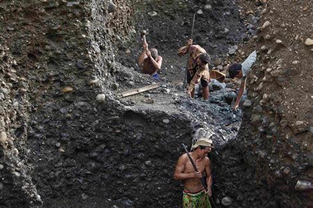 Hand-pickers search for jade through rubble dumped by mining companies at a jade mine in Hpakant township, Kachin State July 7, 2013. REUTERS/Minzayar