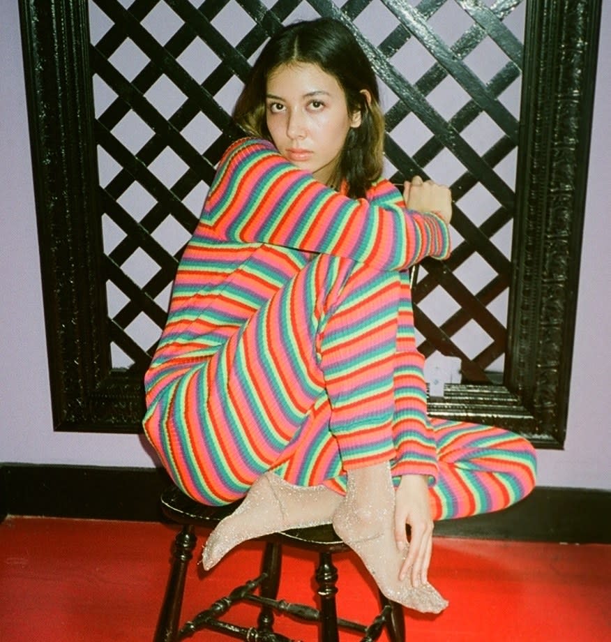Yauch in a striped top-and-pants set based on one worn by Kristen McMenamy on the Spring 1993 runway.