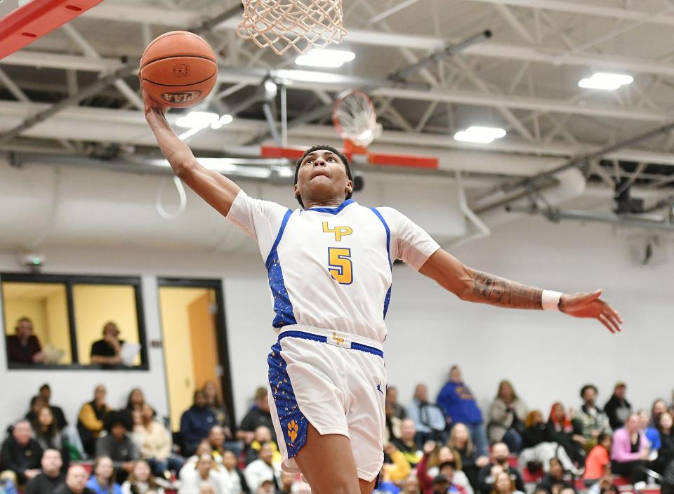 Lincoln Park’s Meleek Thomas goes in for a layup against North Catholic’s Jude Rottmann during a PIAA Class 4A quarterfinal game, Friday at Fox Chapel High School.