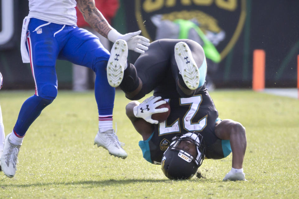 <p>Jacksonville Jaguars running back Leonard Fournette (27) is tackled by the Buffalo Bills defense during the second half of an NFL wild-card playoff football game, Sunday, Jan. 7, 2018, in Jacksonville, Fla. Jaguars beat the Bills 10-3. (AP Photo/Stephen B. Morton) </p>