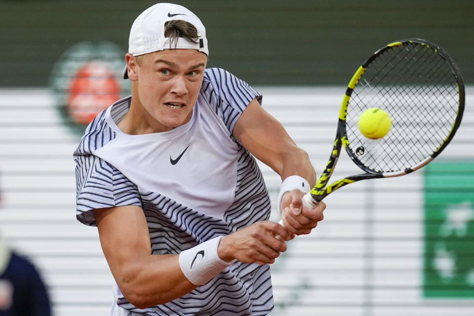 FILE - Denmark's Holger Rune plays a shot against Norway's Casper Ruud during their quarterfinal match of the French Open tennis tournament at the Roland Garros stadium in Paris, Wednesday, June 7, 2023. Rune is expected to compete at Wimbledon next week. (AP Photo/Christophe Ena, File)