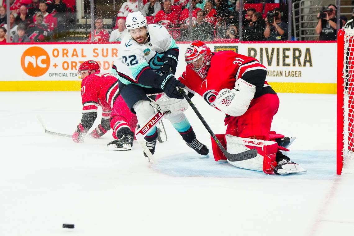Oct 26, 2023; Raleigh, North Carolina, USA; Seattle Kraken right wing Oliver Bjorkstrand (22) in action against Carolina Hurricanes goaltender Frederik Andersen (31) during the over time at PNC Arena. Mandatory Credit: James Guillory-USA TODAY Sports