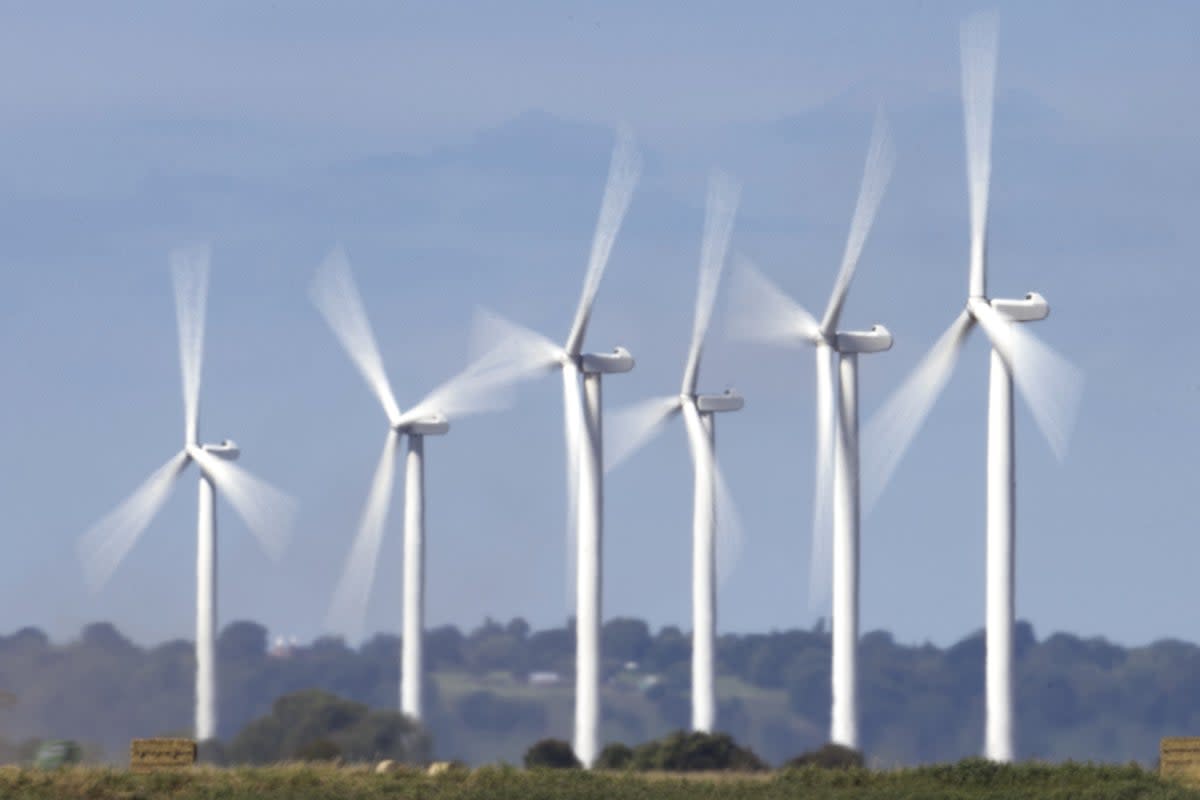  Wind turbines and power lines in Camber, United Kingdom, on 10 August, 2023 (Getty Images)