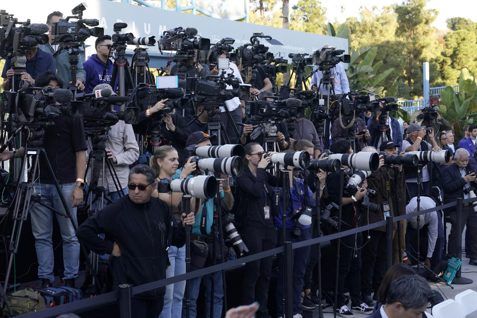 Reporters cover a baseball news conference for Los Angeles Dodgers' Shohei Ohtani at Dodger Stadium Thursday, Dec. 14, 2023, in Los Angeles. (AP Photo/Marcio Jose Sanchez)