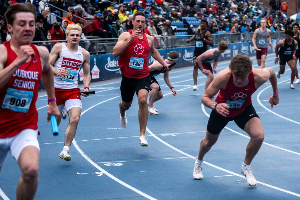 Iowa City High's Phillip Kaplan (left) runs the boys 4x200 meter relay during the Drake Relays at Drake Stadium on Friday, April 26, 2024, in Des Moines.