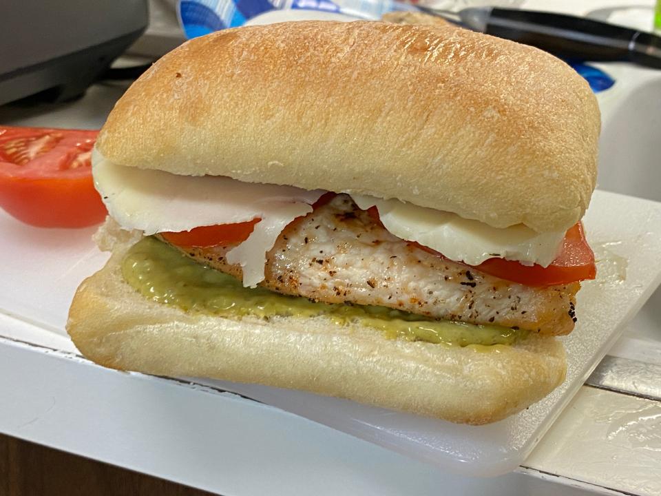 chicken, pesto-mayo and tomato on a sandwich