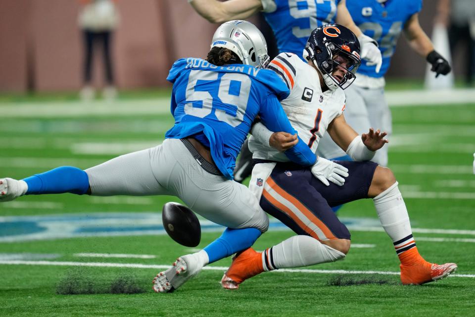 Lions linebacker James Houston (59) knocks the ball away from Bears quarterback Justin Fields during the first half Jan. 1, 2023, in Detroit.