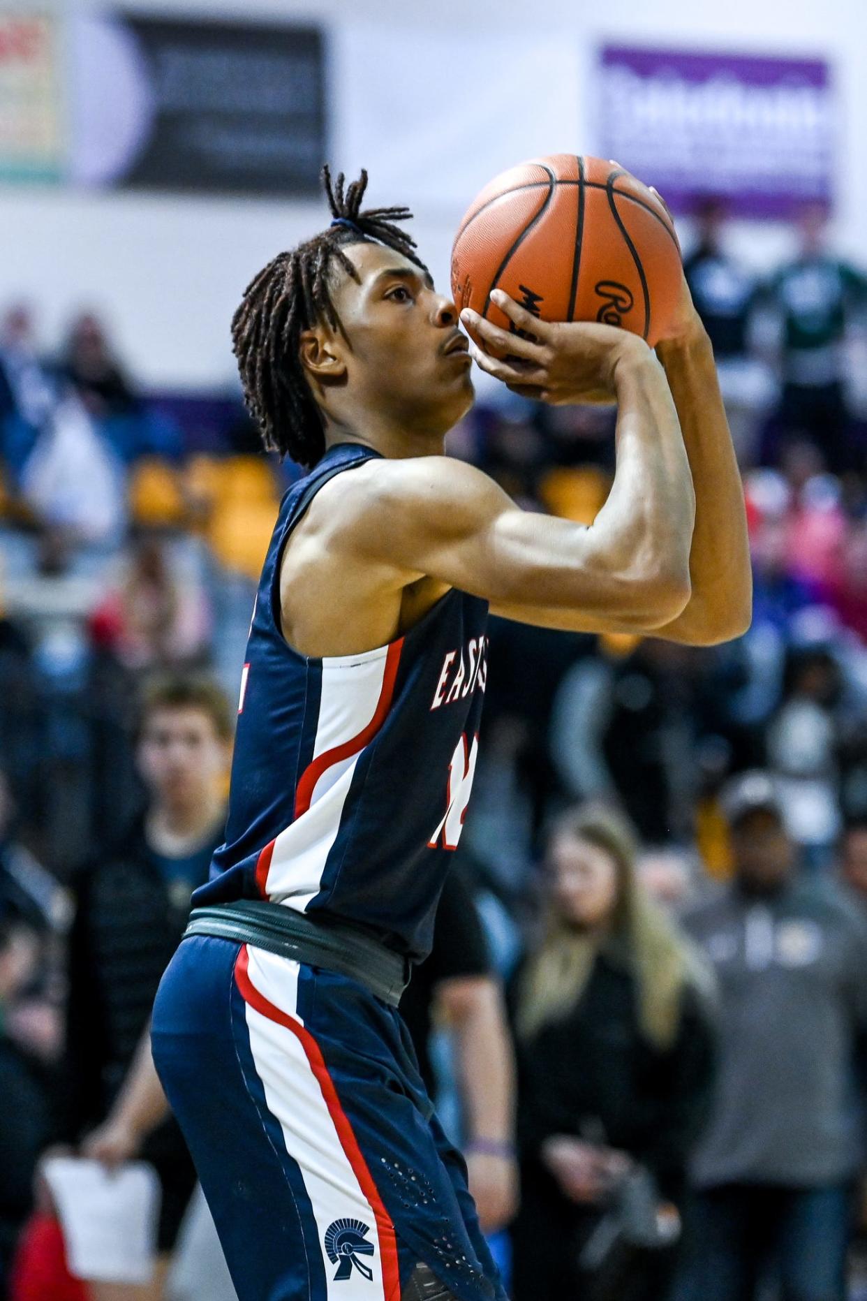 East Lansing's Jayce Branson attempts a 3-pointer against Muskegon during the fourth quarter on Tuesday, March 21, 2023, at Caledonia High School.