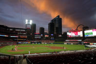 Evening clouds over Busch Stadium are illuminated by the setting sun as the St. Louis Cardinals play the Pittsburgh Pirates during second game of a baseball doubleheader Thursday, Aug. 27, 2020, in St. Louis. (AP Photo/Jeff Roberson)