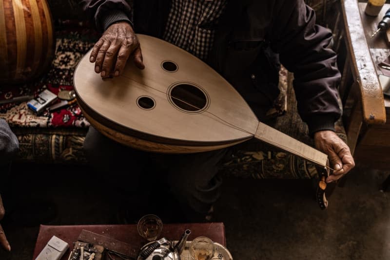 Hasan Hamza, a Syrian musician, here fixing an oud. Anas Alkharboutli/dpa