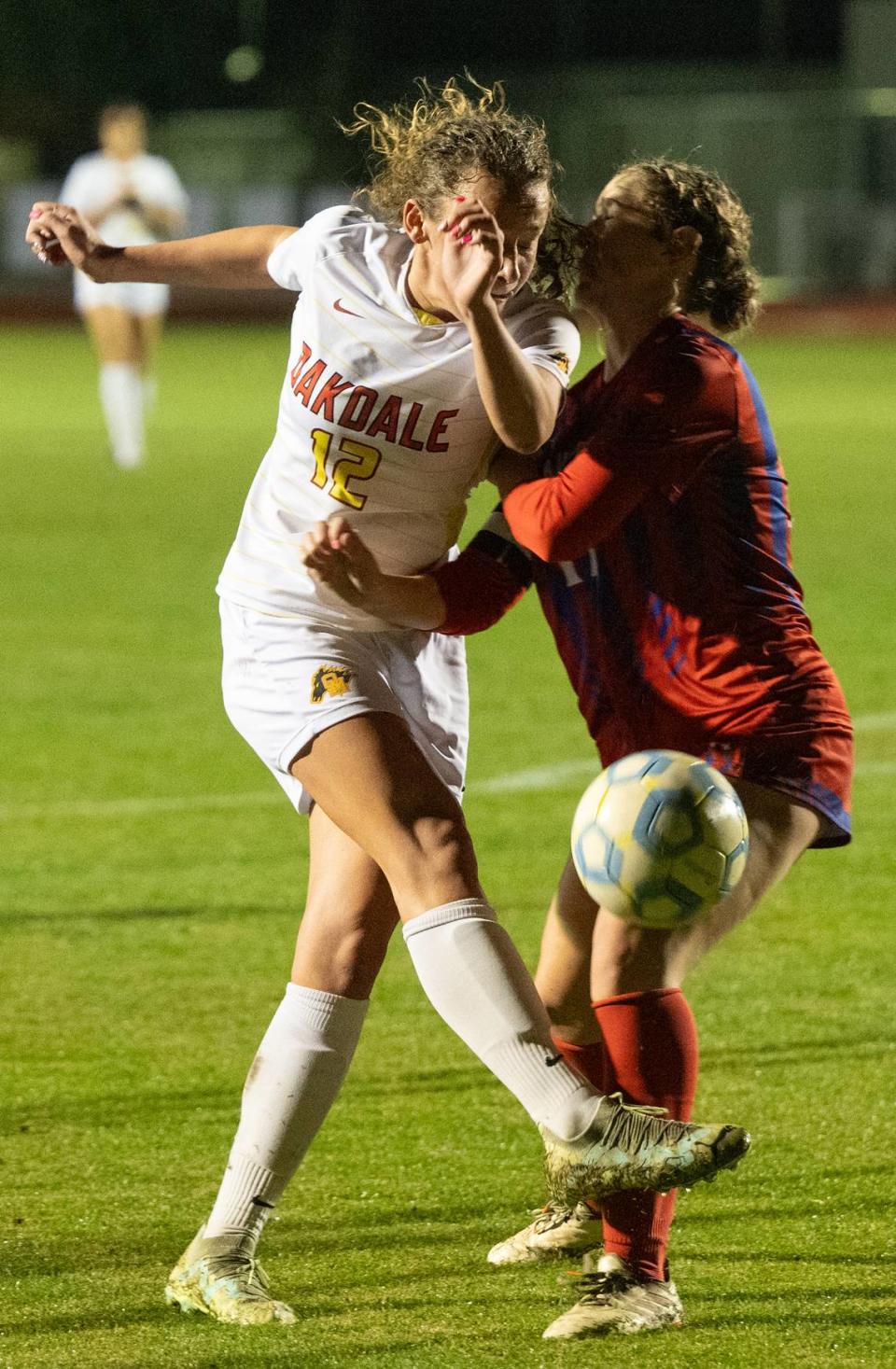 Oakdale’s Dakota Burford kicks the ball past East Union defender Mackenzie Weber during the Valley Oak League game at East Union High School in Manteca, Calif.,Wednesday, Jan. 10, 2024.