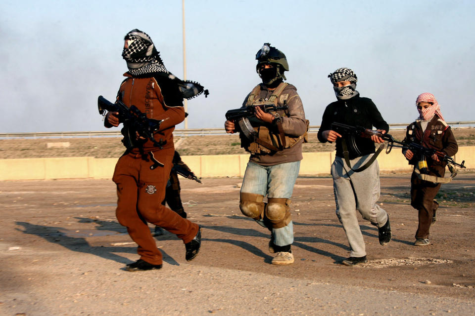 FILE - In this Wednesday, Jan. 15, 2014 file photo, gunmen hold their weapons as they patrol Fallujah, Iraq. More than a month after jihadist militants seized control of parts of Iraq’s western Anbar province, an unsettling realization is sinking in: Iraq’s government could face a tougher time beating back an insurgency there than the hard slog the Americans faced last decade. The reasons include a deep distrust of the government by Iraqi Sunnis, insufficient resources, sectarian tensions enflamed by the war in Syria and divisions among the tribes that make up Anbar’s social fabric. (AP Photo, File)