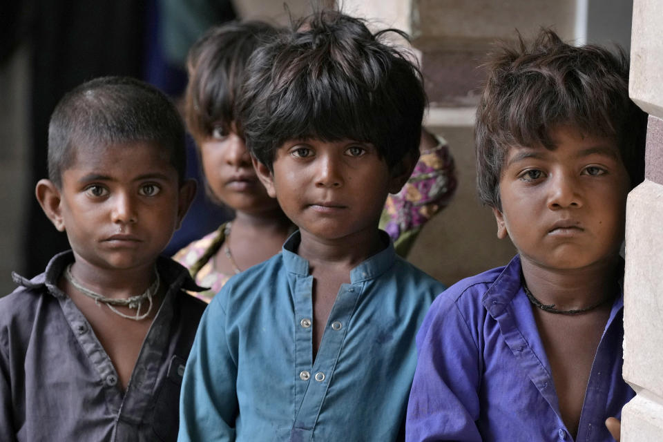 Children gather as they take shelter in a school after fleeing from their villages of costal areas due to Cyclone Biparjoy approaching, in Gharo near Thatta, a Pakistan's southern district in the Sindh province, Wednesday, June 14, 2023. In Pakistan, despite strong winds and rain, authorities said people from vulnerable areas have been moved to safer places in southern Pakistan's districts. With Cyclone Biparjoy expected to make landfall Thursday evening, coastal regions of India and Pakistan are on high alert. (AP Photo/Fareed Khan)