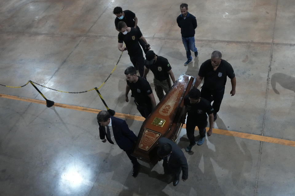 Federal police officers arrive with recovered human remains believed to be of the Indigenous expert Bruno Pereira of Brazil and freelance reporter Dom Phillips of Britain, at the Federal Police hangar in Brasília, Brazil, Thursday,, June 16, 2022. A federal police investigator said a suspect confessed to fatally shooting Pereira and Phillips in a remote part of the Amazon and took officers to where the bodies were buried. (AP Photo/Eraldo Peres)