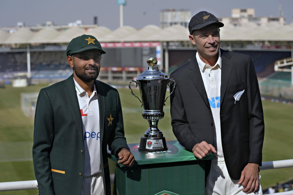 Pakistani skipper Babar Azam, left, and his New Zealand's counterpart Tim Southee pose for a photo with the test series trophy, in Karachi, Pakistan, Sunday, Dec. 25, 2022. (AP Photo/Fareed Khan)