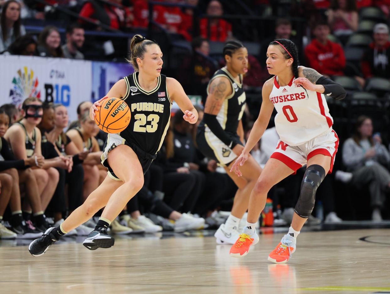 Purdue Boilermakers guard Abbey Ellis #23 drives with the ball as Nebraska Cornhuskers guard Darian White #0 defends in the Second Round of the Big Ten Tournament at Target Center on March 07, 2024 in Minneapolis, Minnesota.