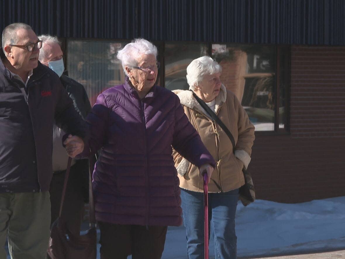 More than a dozen alleged victims of Lowell Oakes, former owner of Dawson Funeral Home in Crapaud, gathered outside provincial court Wednesday. (Brittany Spencer/CBC - image credit)