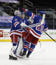 New York Rangers goalie Alexandar Georgiev, left, and teammates celebrate a win over the New York Islanders in an NHL hockey game Saturday, Jan. 16, 2021, in New York. (Bruce Bennett/Pool Photo via AP)