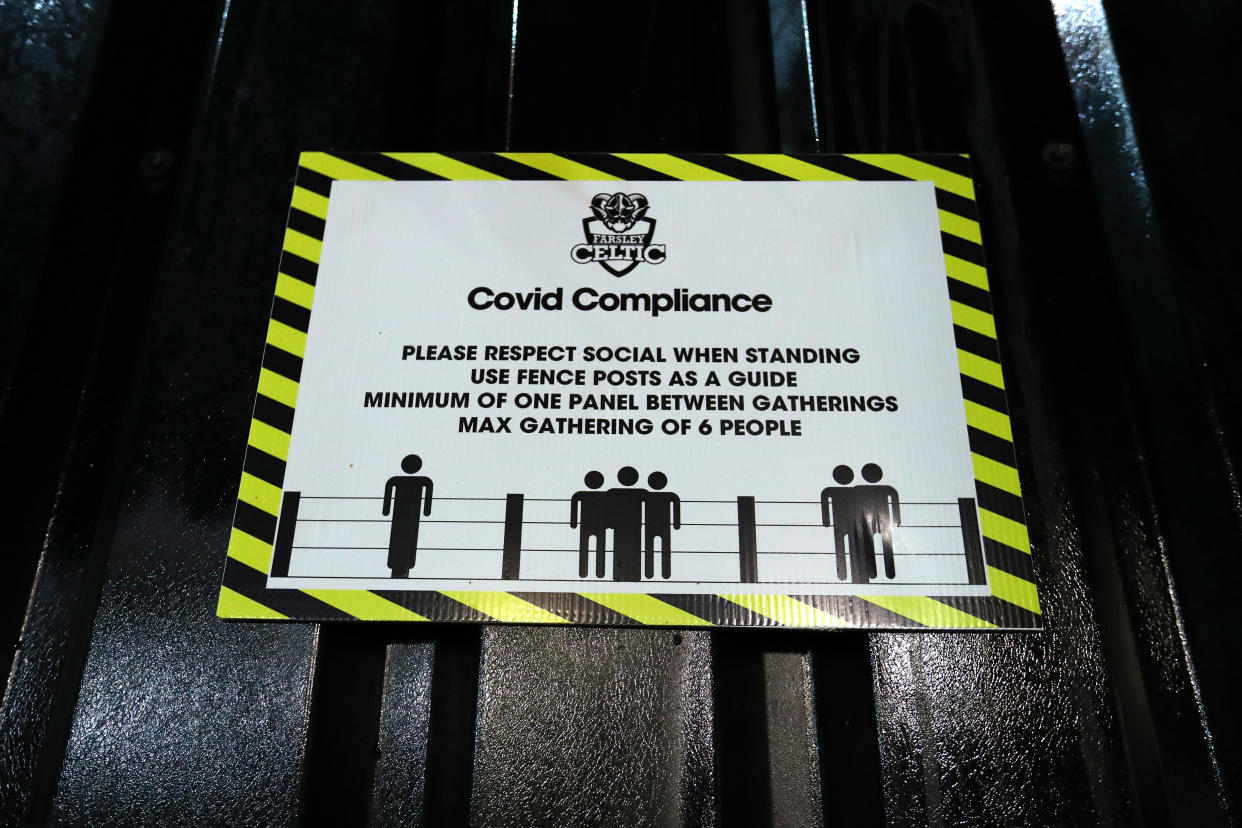 FARSLEY, ENGLAND - OCTOBER 13: A general view of a sign encouraging social distancing inside the stadium during the FA Cup Third Qualifying Round match between Farsley Celtic and AFC Fylde at The Citadel stadium on October 13, 2020 in Farsley, England. Sporting stadiums around the UK remain under strict restrictions due to the Coronavirus Pandemic as Government social distancing laws prohibit fans inside venues resulting in games being played behind closed doors. (Photo by George Wood/Getty Images)