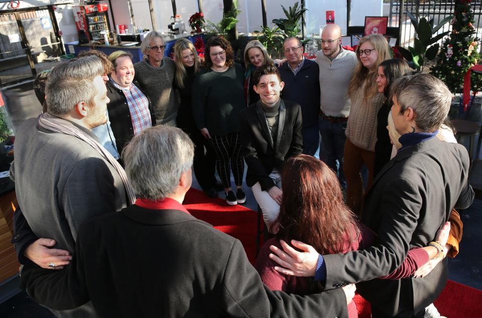 Seacoast Repertory Theatre company member and Red Light series curator Jason Faria is surrounded by actors, board members and staff following last weekend's hate group protest outside the theater. The hate group was protesting Faria's drag queen show for children, as he is the main character in "Honey Punch & Pals."