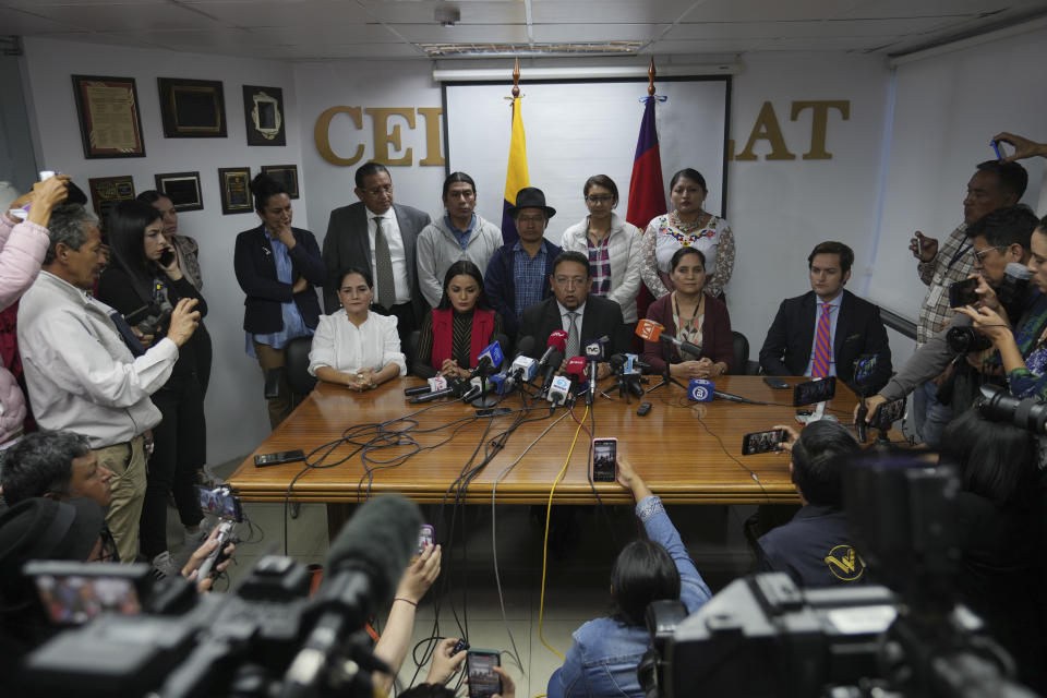 The president of Ecuador´s dissolved National Assembly Virgilio Saquicela, center, surrounded by other lawmakers, speaks during a press conference in Quito, Ecuador, Wednesday, May 17, 2023. Ecuadorian President Guillermo Lasso put an end to impeachment proceedings against him by dissolving the opposition-led National Assembly, which had accused him of embezzlement. (AP Photo/Dolores Ochoa)