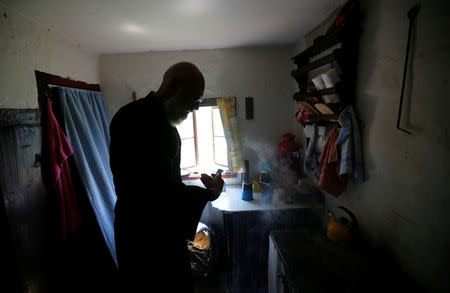 Hermit Stan Vanuytrecht of Belgium prepares coffee in the hermitage in Saalfelden, Austria, May 22, 2017. Picture taken May 22, 2017. REUTERS/Leonhard Foeger