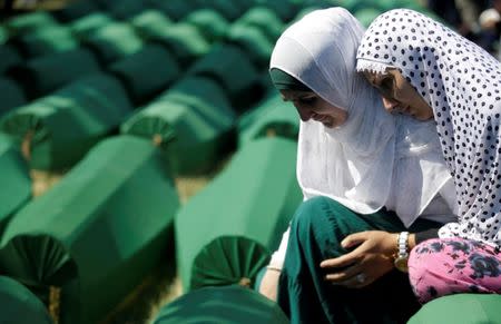 Muslim women cry near coffins of their relatives, who are newly identified victims of the 1995 Srebrenica massacre, which are lined up for a joint burial in Potocari near Srebrenica, Bosnia and Herzegovina July 11, 2016. REUTERS/Dado Ruvic/Files