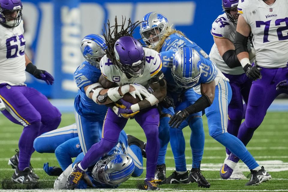 Minnesota Vikings' Dalvin Cook is stopped during the first half of an NFL football game against the Minnesota Vikings Sunday, Dec. 11, 2022, in Detroit. (AP Photo/Paul Sancya)