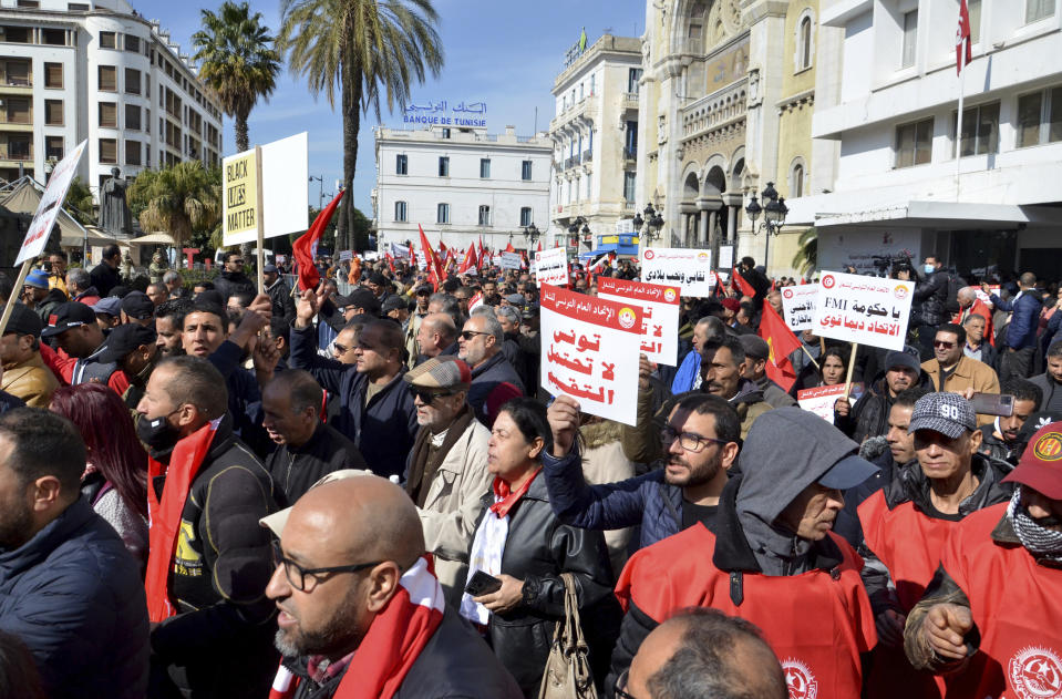 Members of the Tunisian General Labor Union (UGTT) take part in a protest against president Kais Saied policies, in Tunis, Tunisia, Saturday, March 4, 2023. Banner in Arabic reads "Tunisia can't afford divisions." (AP Photo/Hassene Dridi)