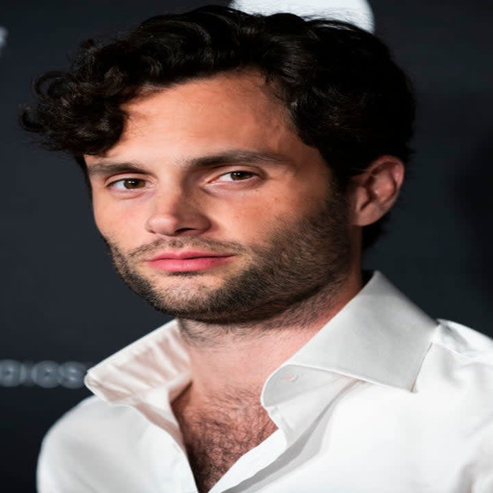 Penn Badgley at a red carpet event in a plain dress shirt