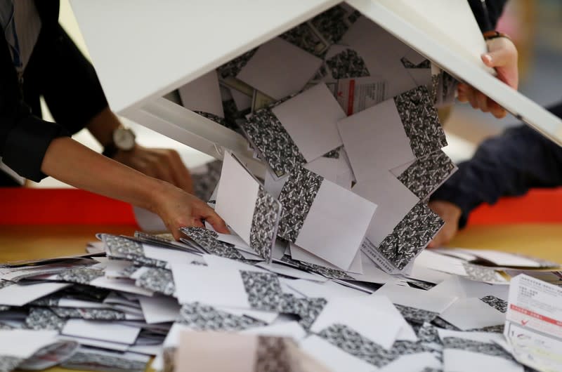 Officials open a ballot box at a polling station in Kowloon Tong, Hong Kong