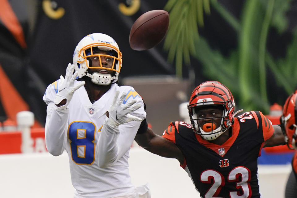 Los Angeles Chargers' Mike Williams (81) makes a catch against Cincinnati Bengals' Darius Phillips (23) during the first half of an NFL football game, Sunday, Sept. 13, 2020, in Cincinnati. (AP Photo/Bryan Woolston)