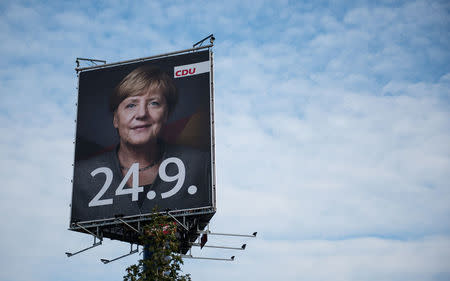 An election campaign poster for the upcoming general elections of the Christian Democratic Union party (CDU) with a headshot of German Chancellor Angela Merkel is displayed in Wustermark near Berlin, Germany, September 20, 2017. REUTERS/Stefanie Loos