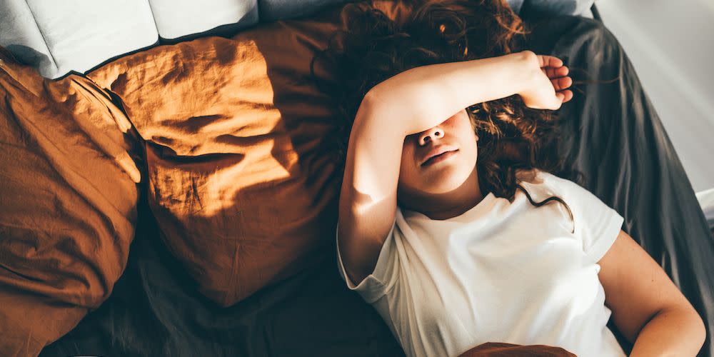 morning anxiety top view of woman laying on bed in bad mood unhappy female at home alone