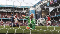 Finland's Joel Pohjanpalo, on the ground, scores the decisive goal against Denmark's goalkeeper Kasper Schmeichel during the Euro 2020 soccer championship group B match between Denmark and Finland at Parken stadium in Copenhagen, Saturday, June 12, 2021. (AP Photo/Martin Meissner, Pool)